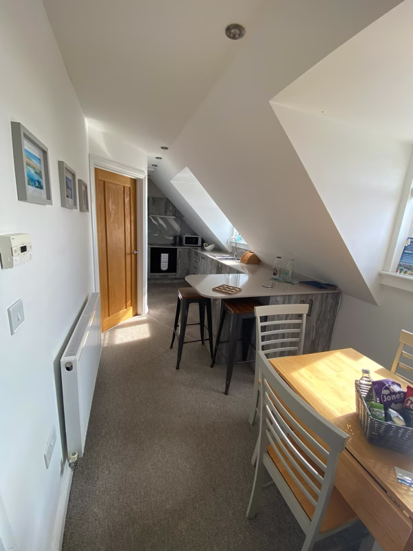 Sea Dream Lodge — open-plan kitchen and dining area with bar stools